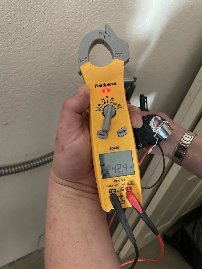 Voltage testing with clamp meter during Whole House Surge Protector in North Beaver